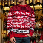 Man wearing a red and white Christmas sweater with a reindeer and snowflake print
