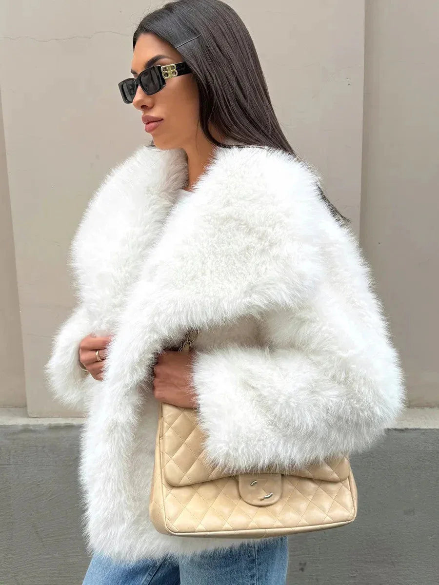 Side profile of a woman in a luxurious faux fur jacket