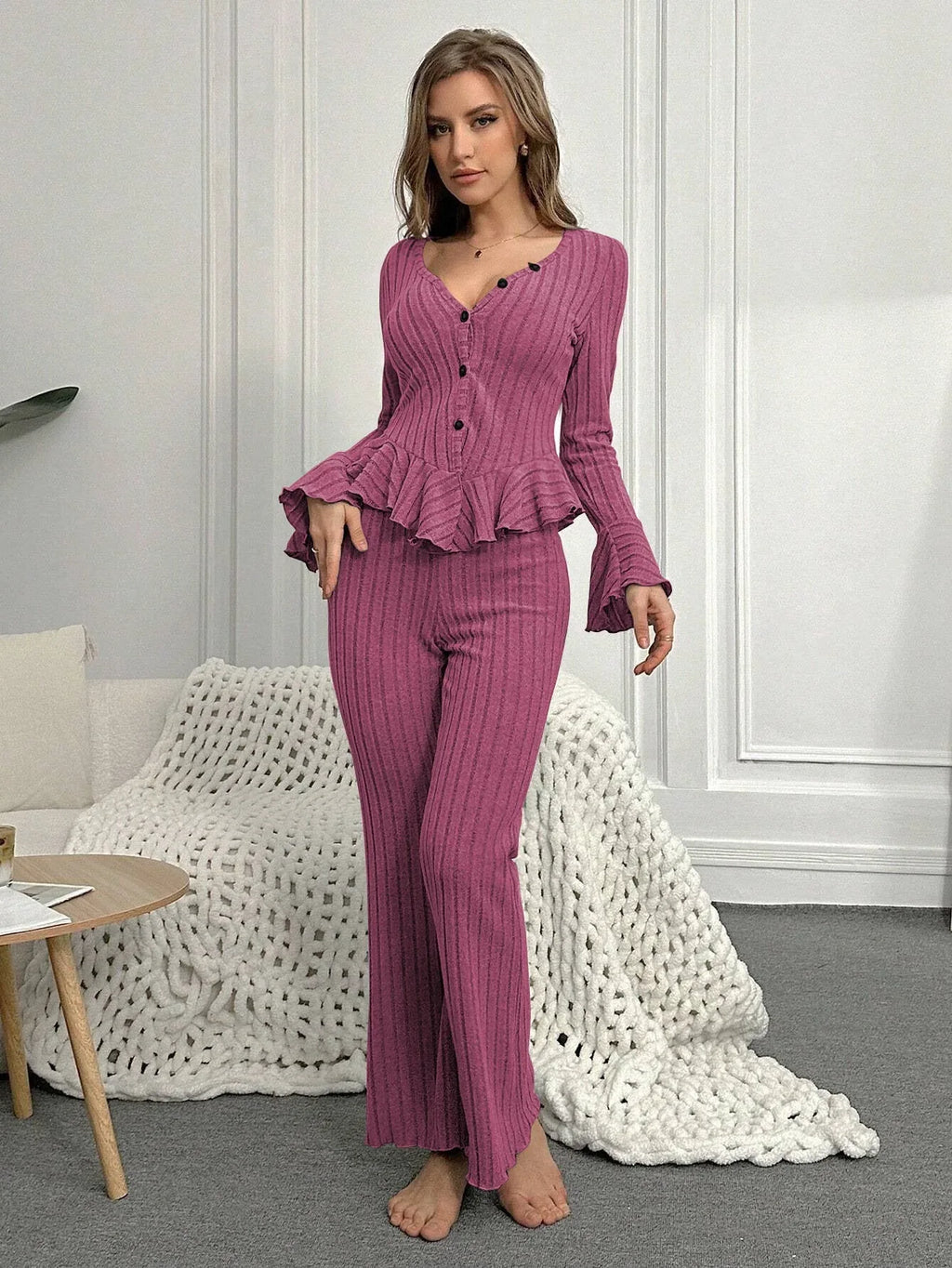 Woman wearing a purple ribbed peplum lounge set standing