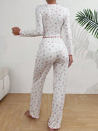 back view of woman in white floral print pajama set