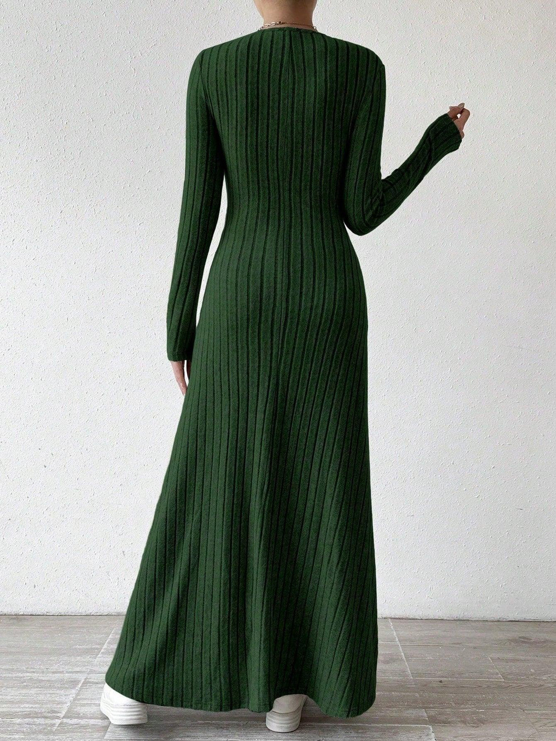 Woman wearing a green ribbed knit maxi dress