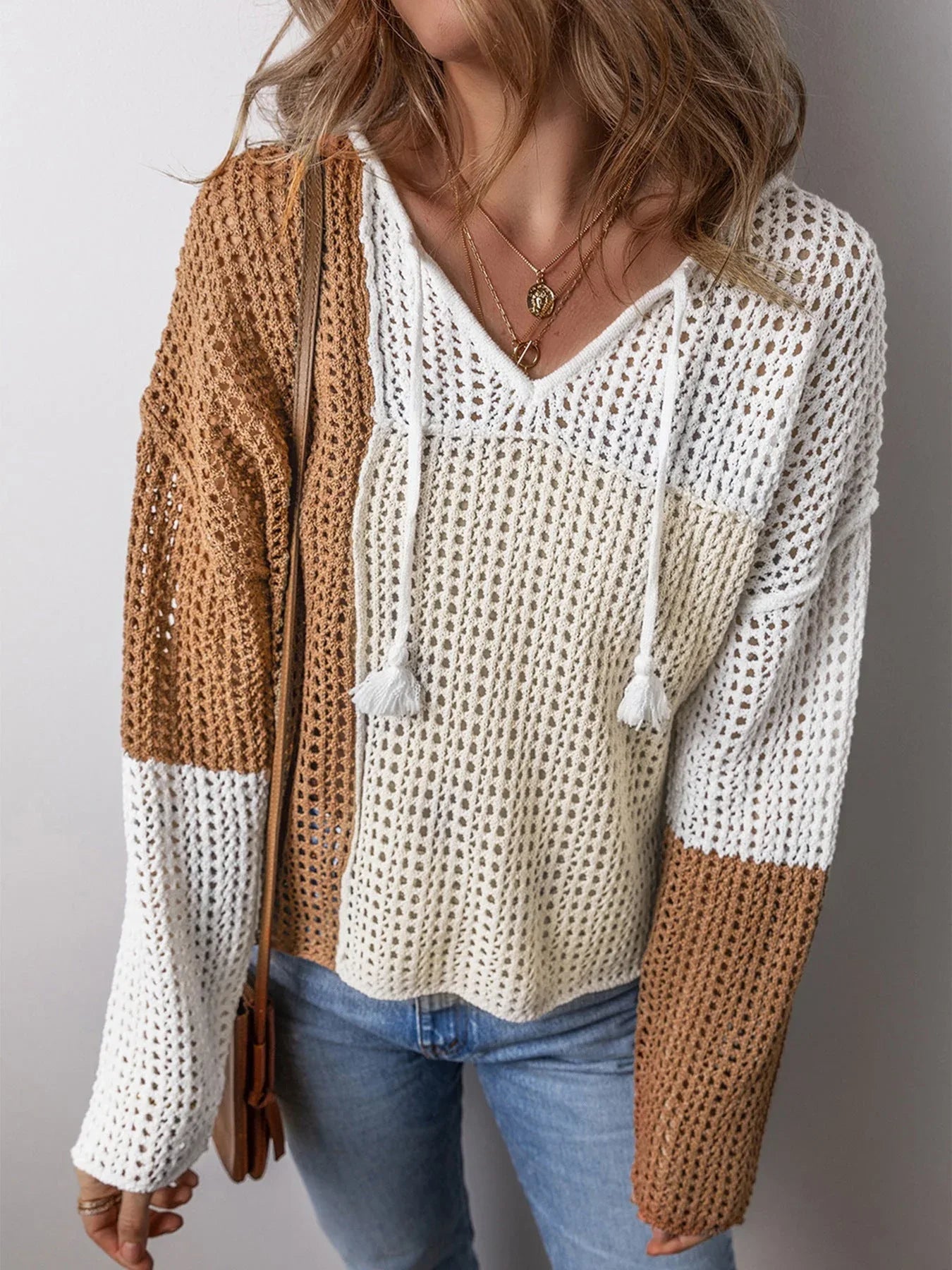 Woman from the front in a casual color block knit hoodie