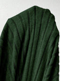 Close-up of dark green ribbed knit fabric