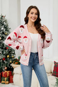 Woman wearing a pink Santa Claus print knit cardigan with a V-neck and button-down front.