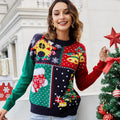 Woman wearing a festive patchwork holiday knit sweater with a gingerbread house design.