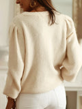 Back view of cream knit cardigan with puff sleeves