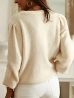 Back view of cream knit cardigan with puff sleeves
