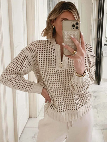 Woman wearing a cream-colored open knit quarter-zip sweater