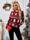 Woman holding a red gift box while wearing a festive knit sweater.