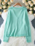 Back view of a mint green V-neck knit cardigan