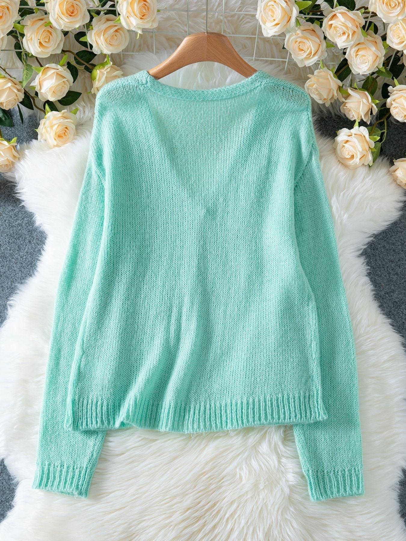 Back view of a mint green V-neck knit cardigan