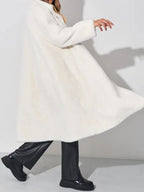 woman twirling in a white faux fur coat