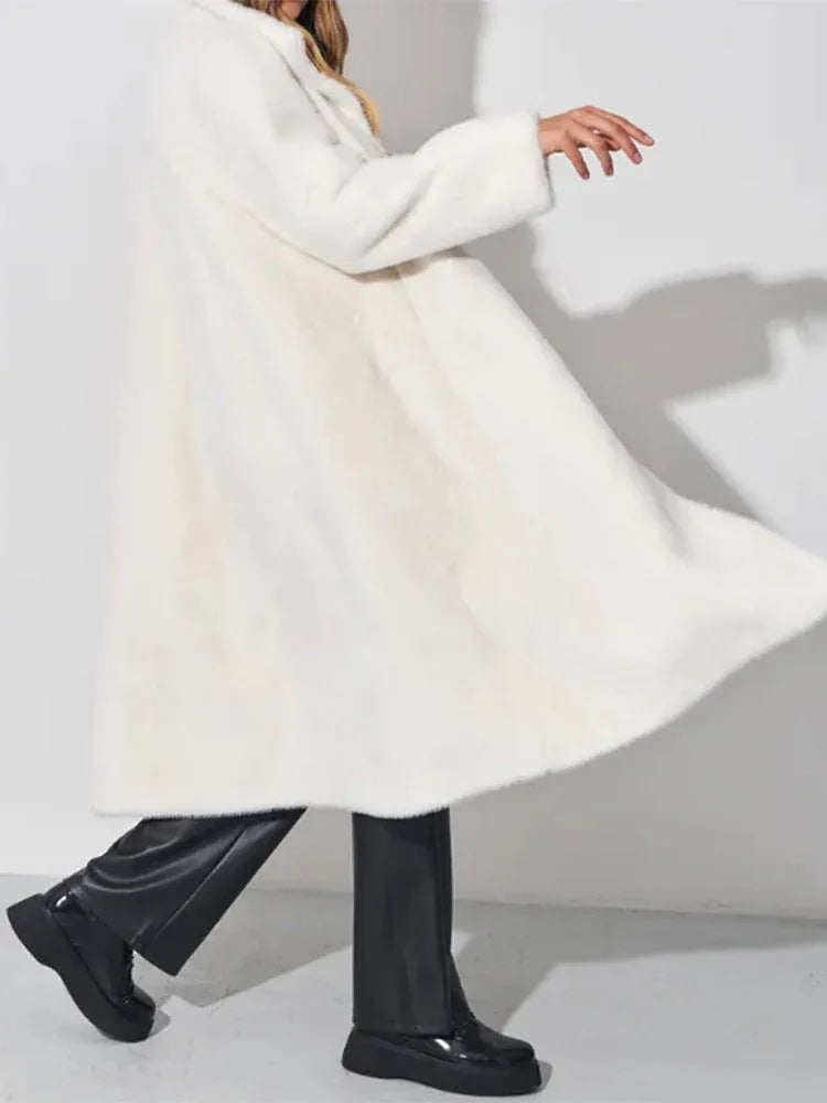 woman twirling in a white faux fur coat
