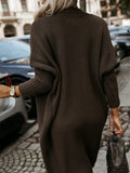 Rear view of a woman wearing a long brown ribbed knit cardigan, showcasing the back and sleeve details.