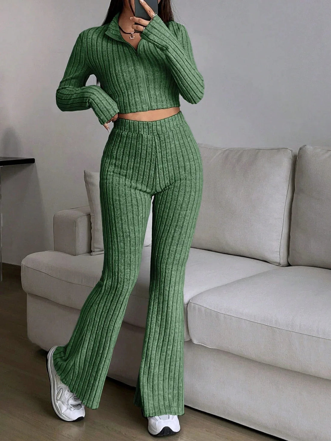 Woman wearing a green ribbed knit cropped top and flared pants set
