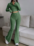 Woman wearing a green ribbed knit cropped top and flared pants set