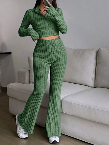 Woman wearing a green ribbed knit cropped top and flared pants set