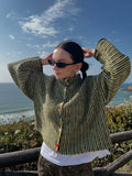 Close-up of the multi-colored buttons on a chevron knit cardigan