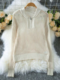 Cream open knit sweater with a quarter-zip closure displayed on a hanger