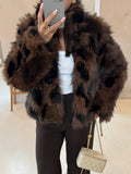 Woman wearing a dark brown and black patterned faux fur jacket with dark pants