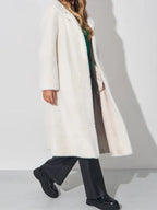 woman in white faux fur coat walking