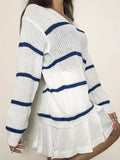Side profile of a woman wearing a white and navy blue striped knit sweater.