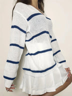 Side profile of a woman wearing a white and navy blue striped knit sweater.