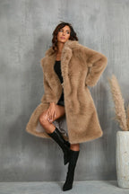 Woman wearing a tan faux fur coat with a notched lapel collar.