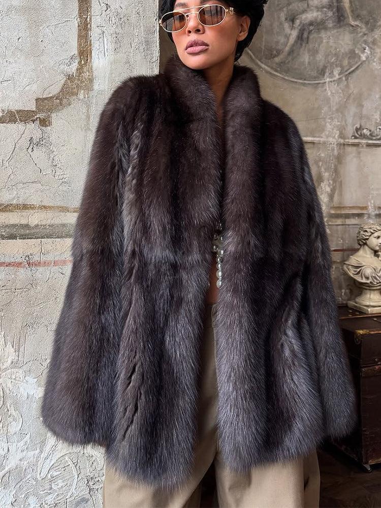 Front view of a woman wearing a plush dark brown fur coat with a prominent collar.