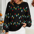 Close-up of a festive knit sweater with colorful light bulb design