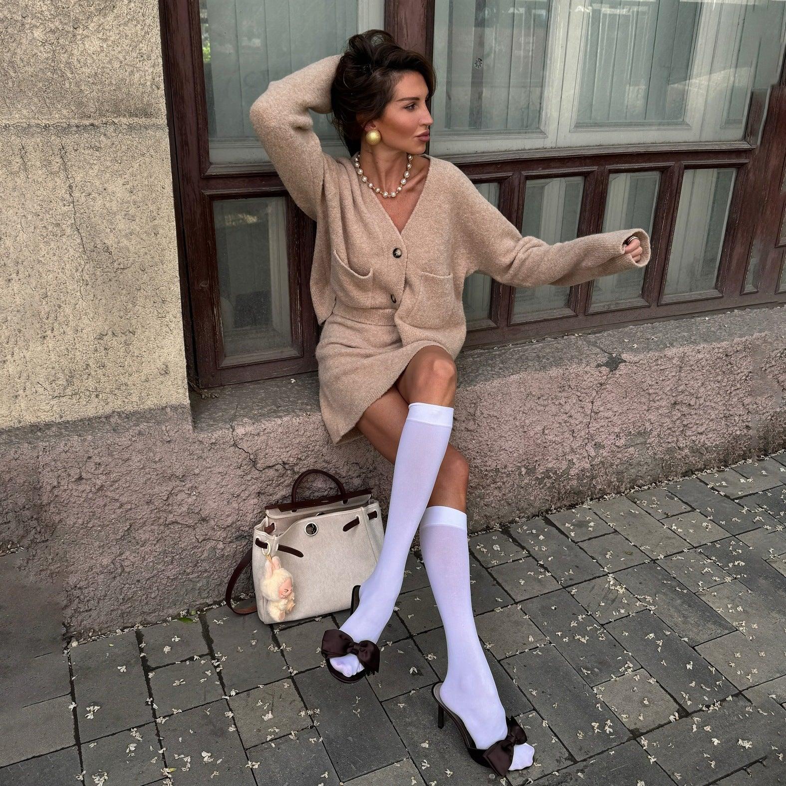 Model posing in a comfortable oatmeal knit co-ord set outdoors