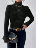 Close-up of a black ribbed knit turtleneck sweater