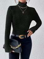 Close-up of a black ribbed knit turtleneck sweater