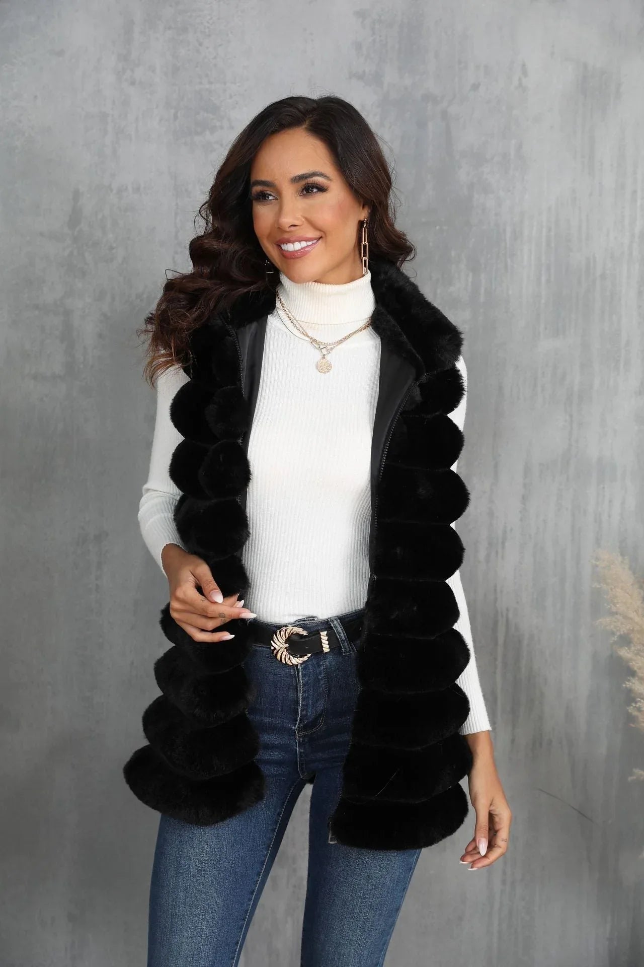 Front view of a woman wearing a black faux fur vest and gold jewelry