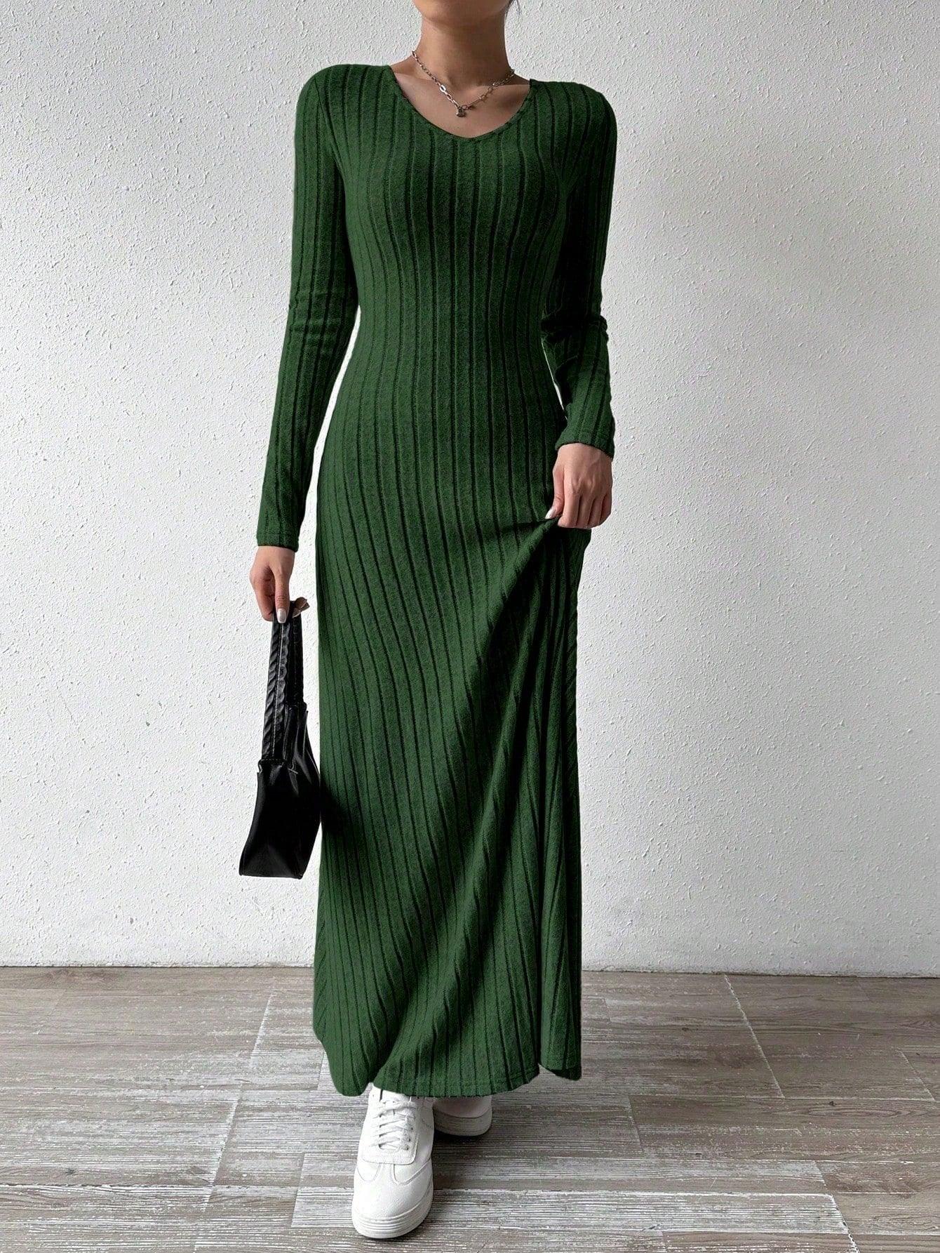 Person holding the hem of a ribbed knit maxi dress