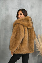 Back view of a woman in a brown faux fur hooded jacket