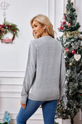 Rear view of the grey knit Christmas sweater, showing the long sleeves and crew neckline.