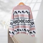 Back view of a pink, white, and black geometric pattern knit cardigan with balloon sleeves.