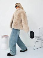 Woman walking in a beige faux fur cropped jacket