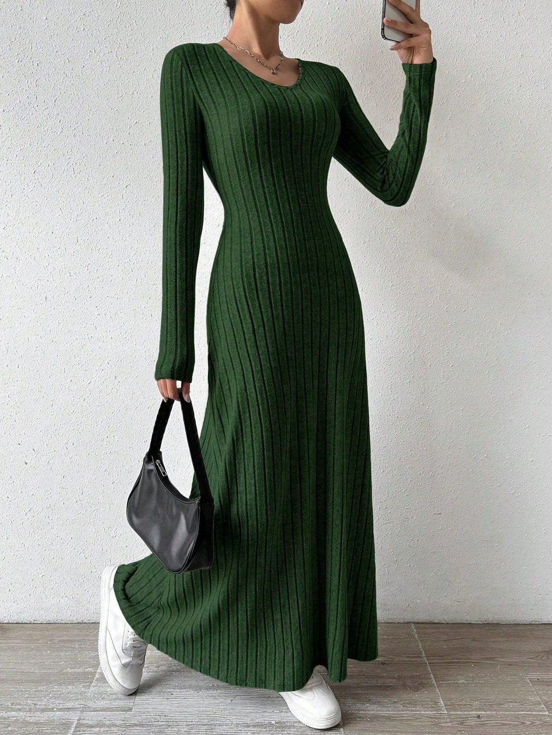 Woman wearing a green ribbed knit maxi dress