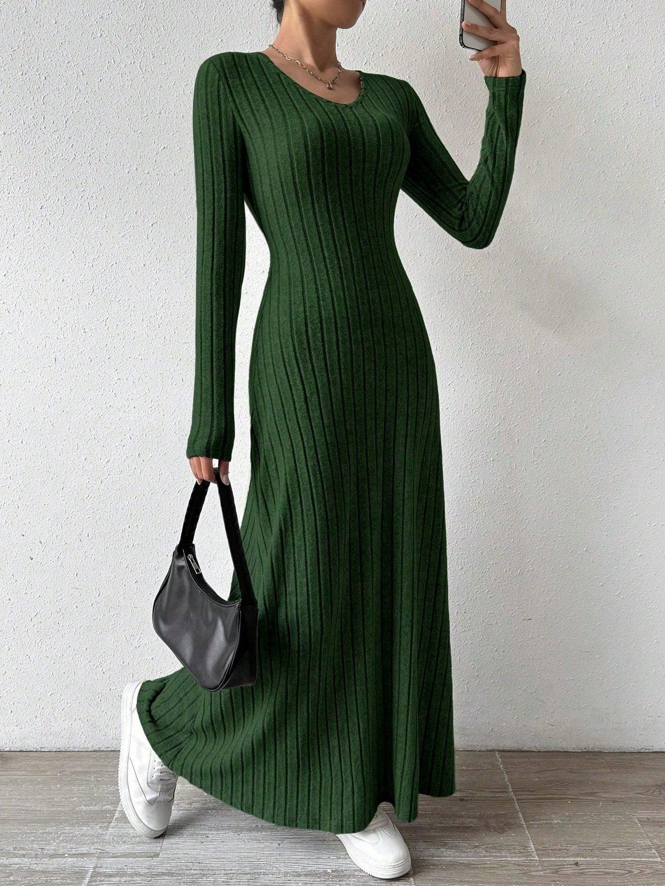 Woman wearing a green ribbed knit maxi dress