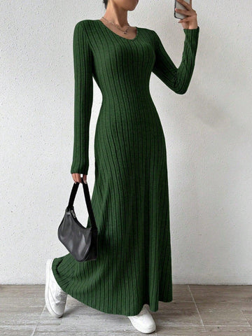 Woman wearing a green ribbed knit maxi dress