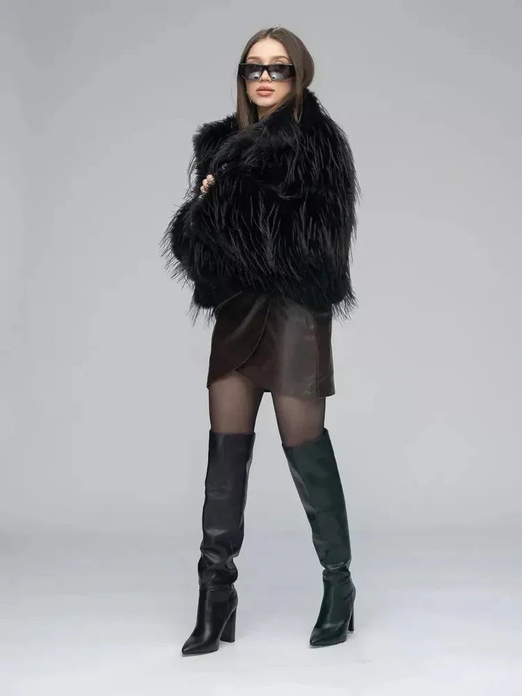 Woman wearing a black shaggy faux fur jacket with a brown faux leather wrap dress and black boots