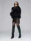 Side view of a woman in a black shaggy faux fur jacket and brown faux leather wrap dress