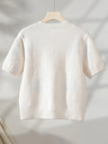 Back view of a cream knit cardigan