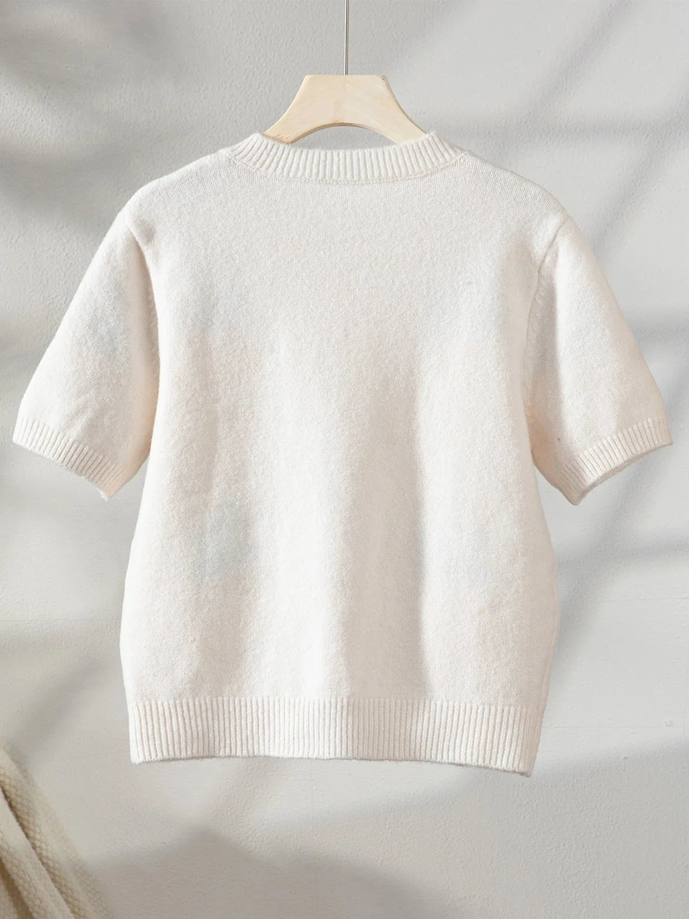Back view of a cream knit cardigan