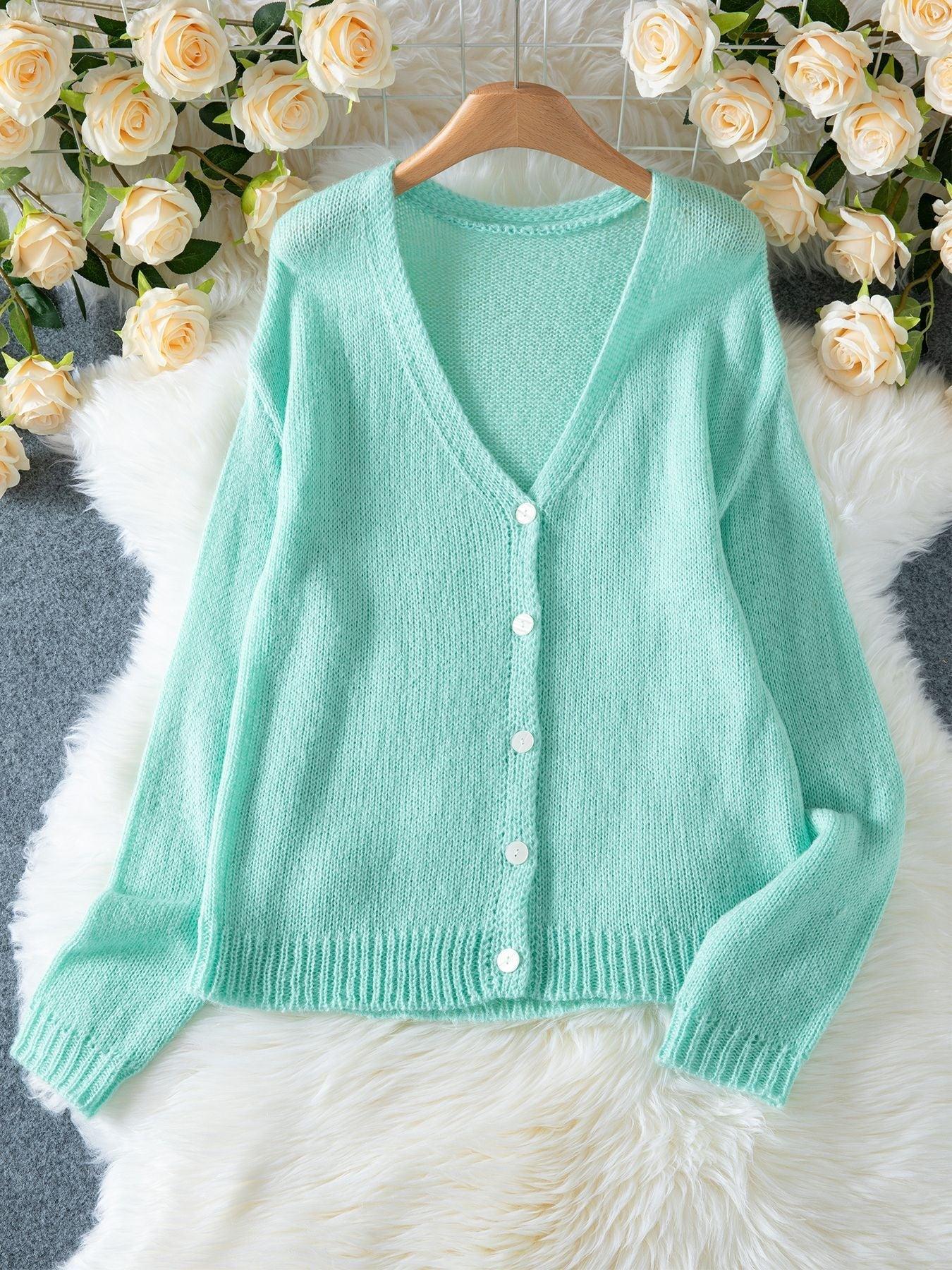 Mint green V-neck knit cardigan laid flat