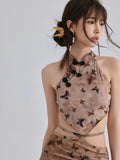 Close-up of the halter crop top with a butterfly print and traditional knot buttons.