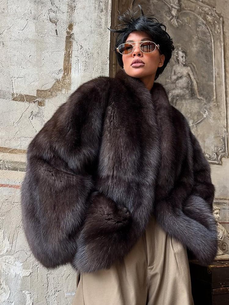Full body shot of a woman styled in a luxurious dark brown fur coat and wide-leg pants.