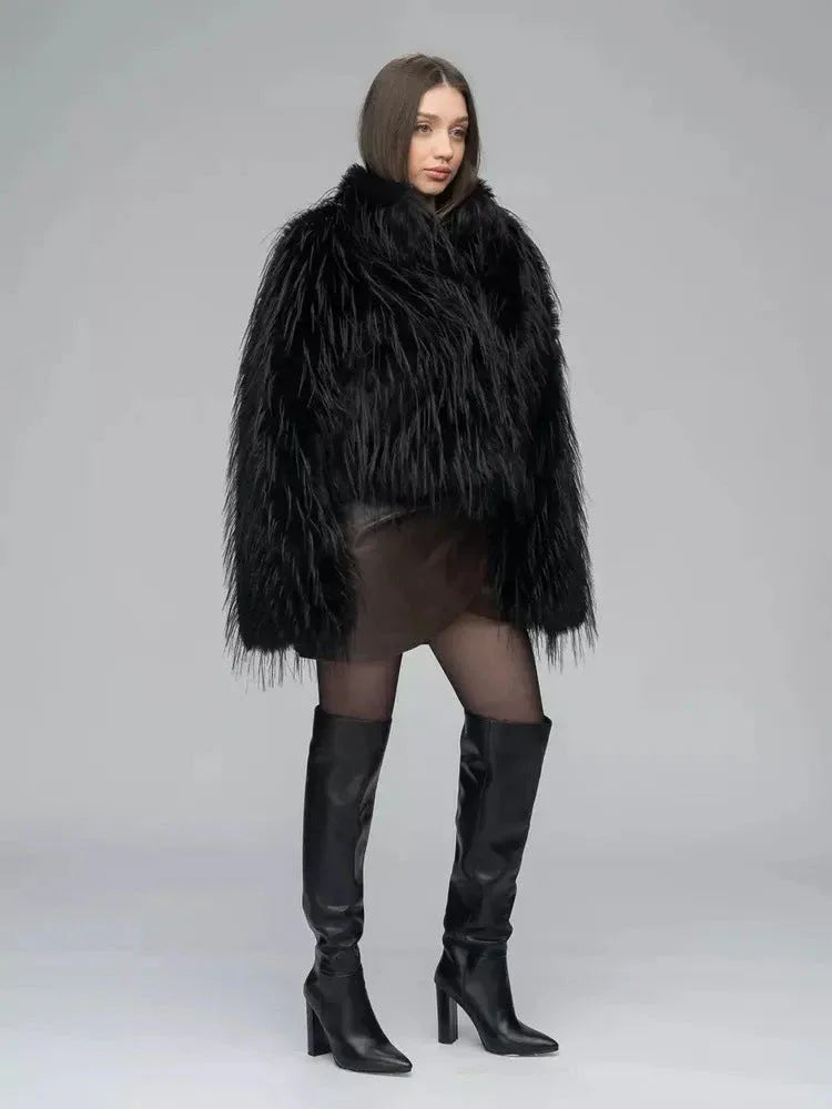 Rear view of a woman in a black shaggy faux fur jacket and brown faux leather wrap dress